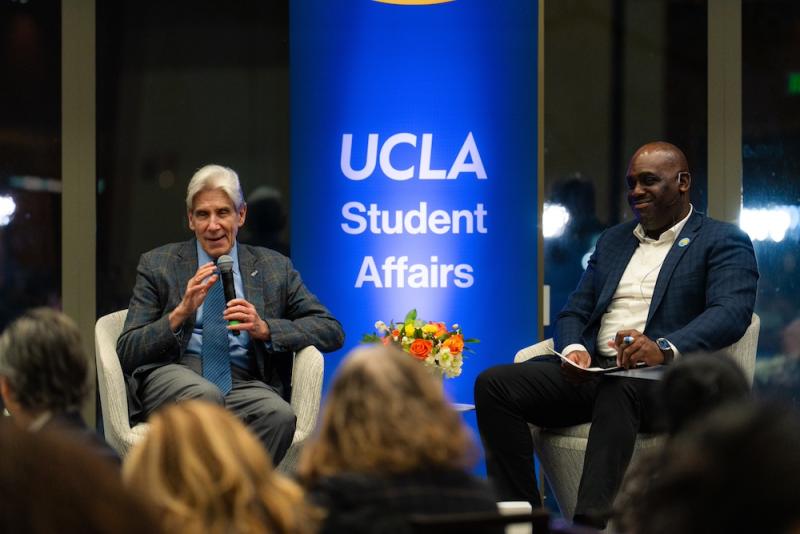 UCLA Chancellor Julio Frenk and Vice Chancellor of Student Affairs Monroe Gorden Jr sitting on a stage talking to a crowd.