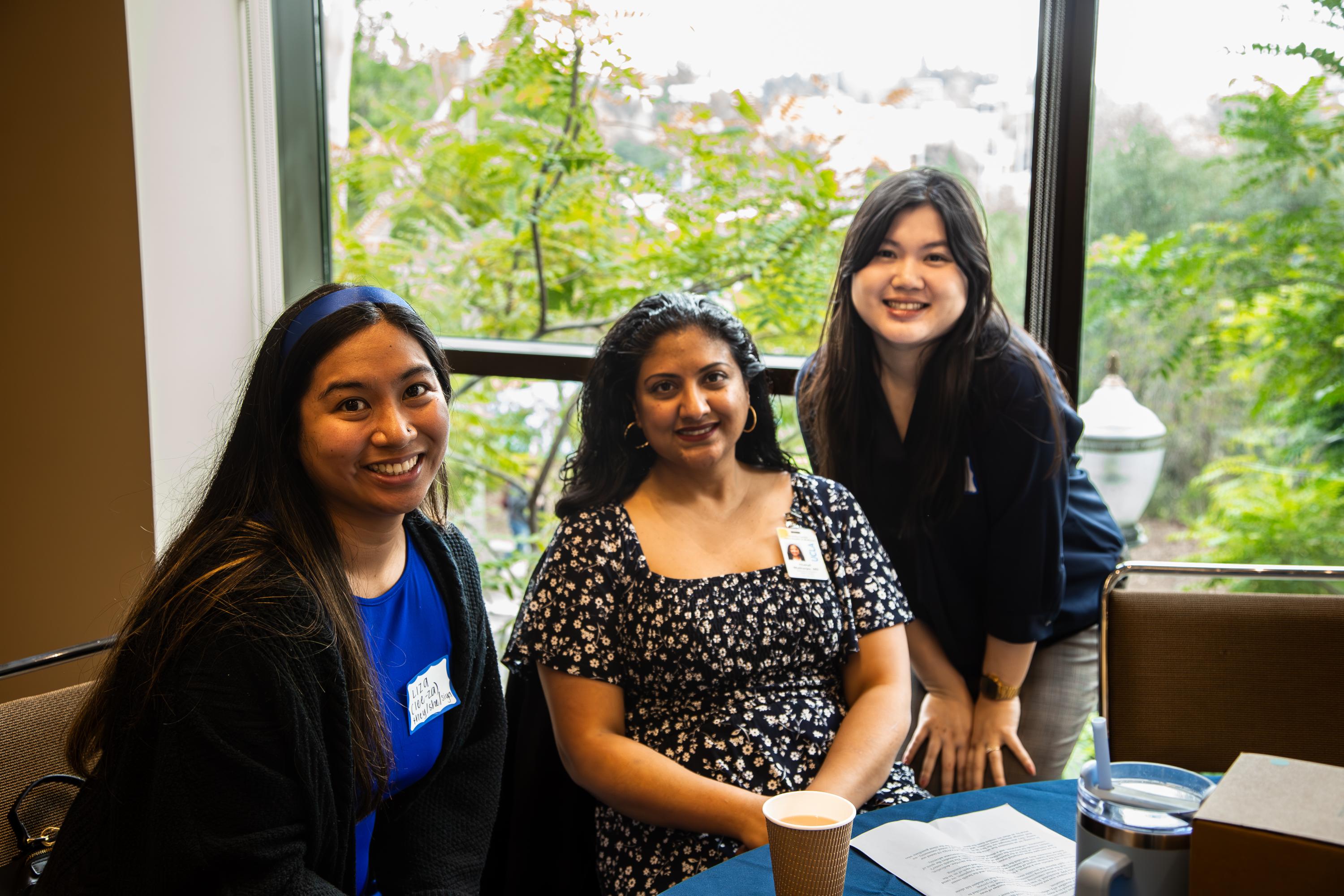 Photo of three staff members smiling at camera.