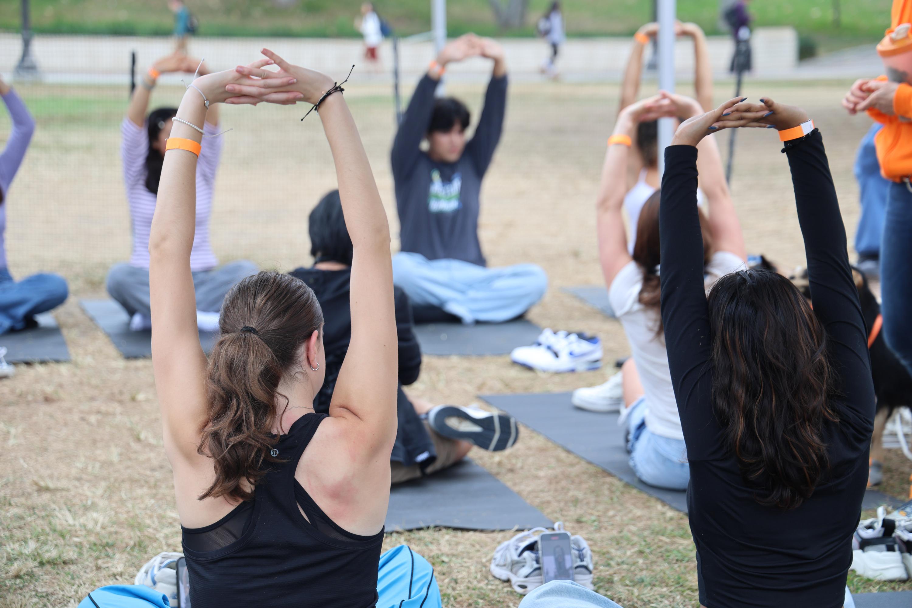 Students doing yoga outside.