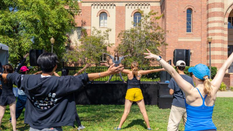 Students doing yoga outside.
